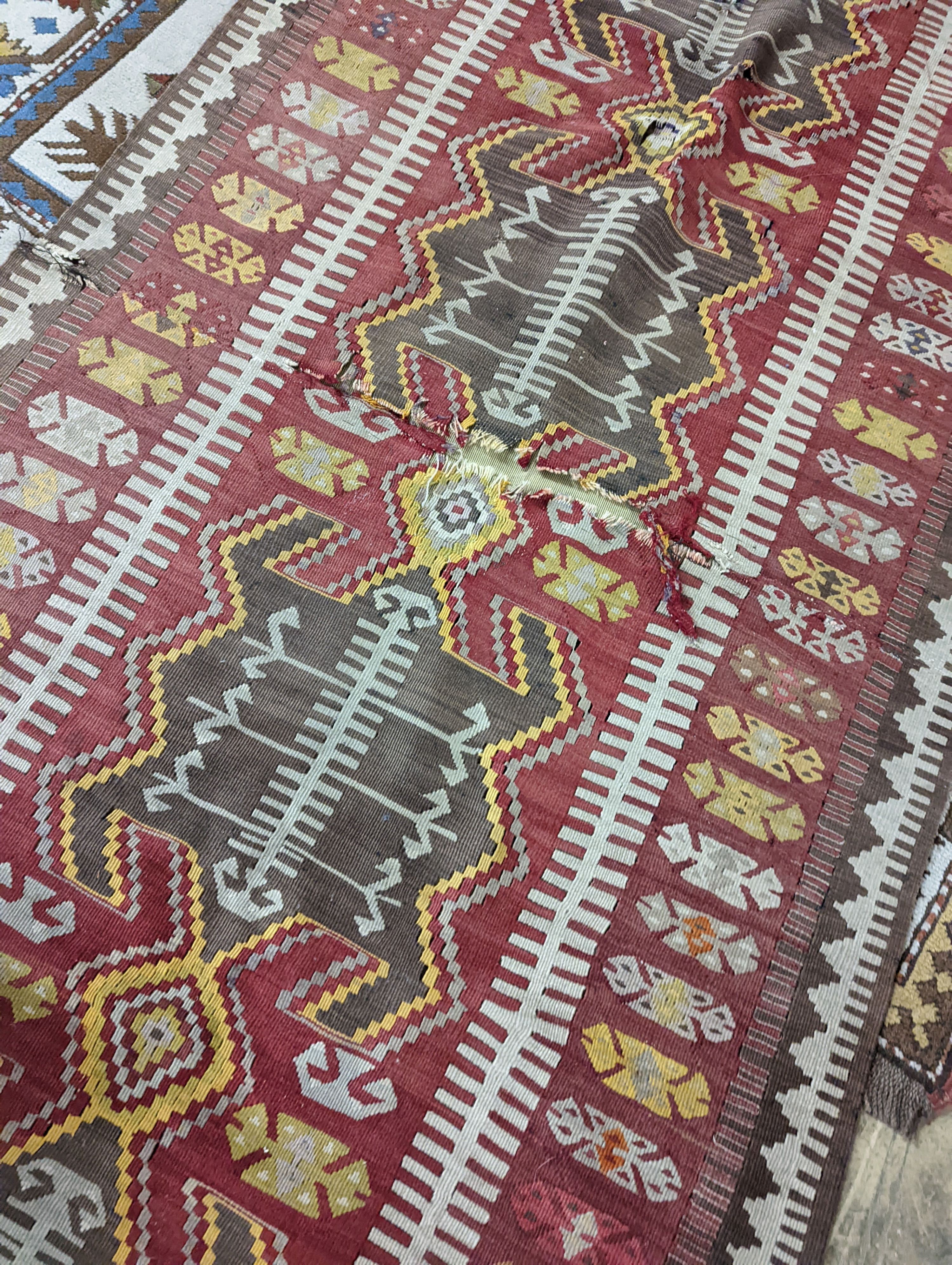 A Kilim polychrome flatweave runner, 380 x 118cm (holed)